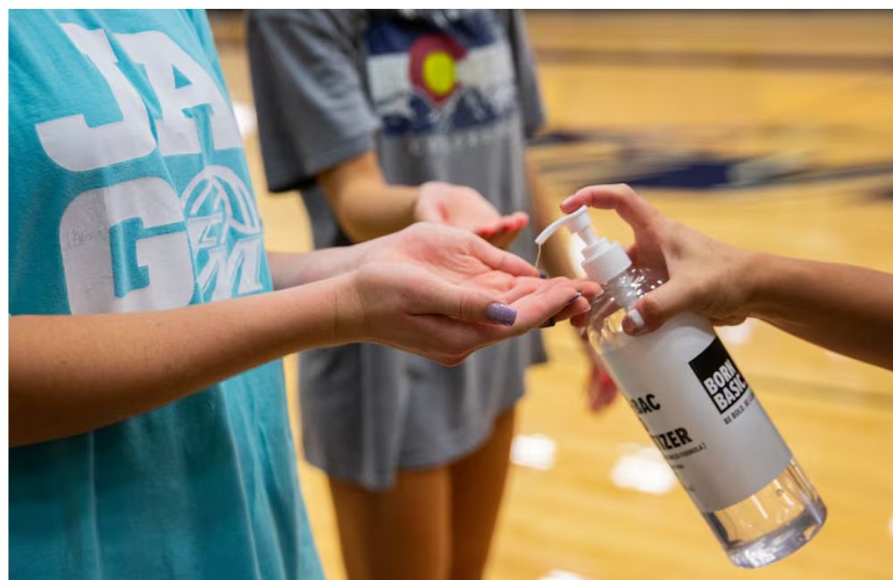 An image of a teach applying hand sanitizer to represent the horrible fire experiment.